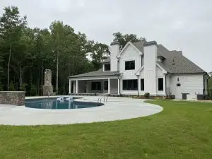 Beautiful, modern, two story home with back patio built by VC Custom Homes. Beautiful green grass and pool.