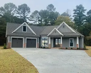 Front of beautiful, modern, one-story home with two-car garage.